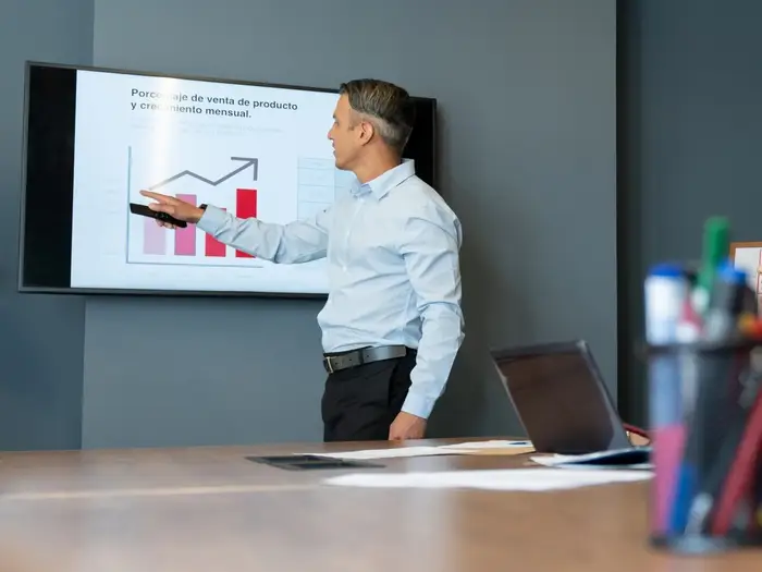 University student preparing a PowerPoint presentation on a laptop